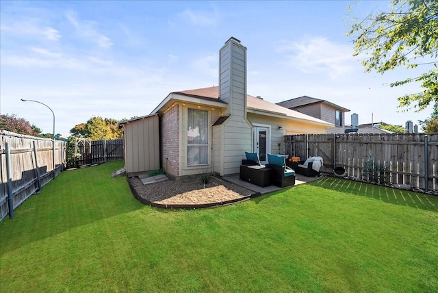 back of house featuring an outdoor living space and a yard