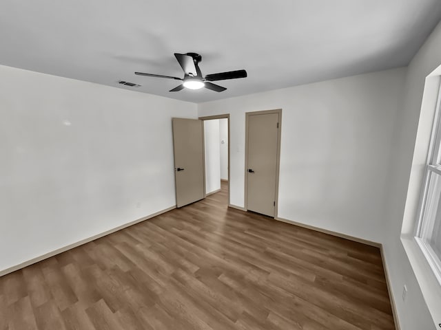 unfurnished bedroom with ceiling fan and hardwood / wood-style flooring