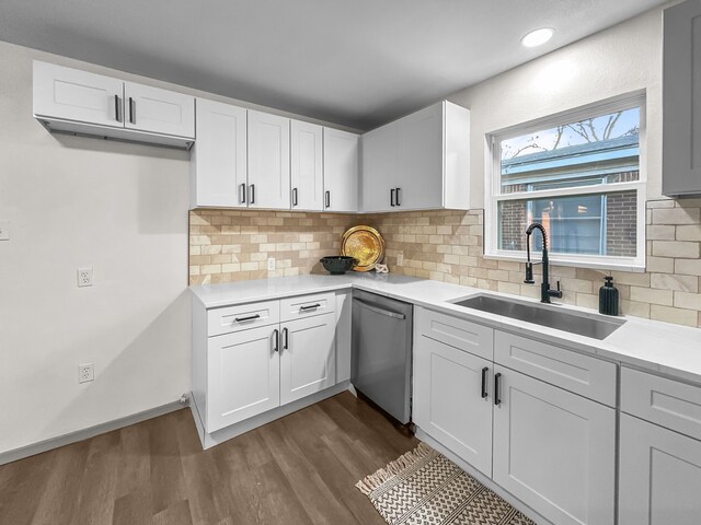 kitchen featuring white cabinets, backsplash, dark wood-type flooring, and appliances with stainless steel finishes