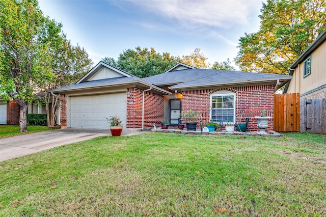 ranch-style house featuring a front yard and a garage