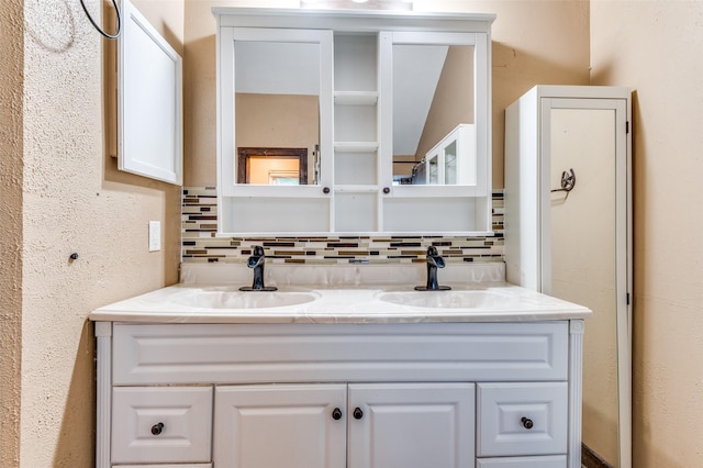 bathroom with vanity and tasteful backsplash