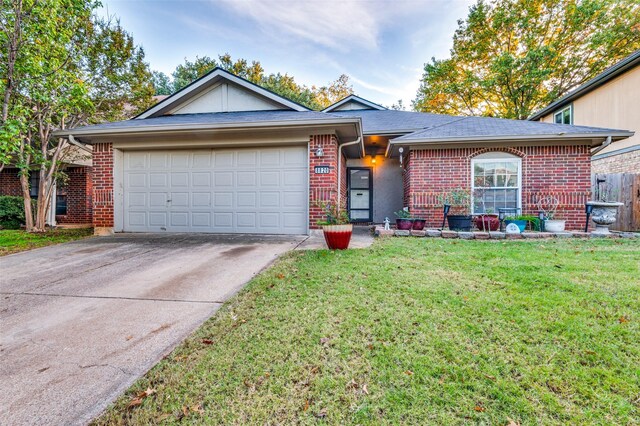 single story home featuring a front yard and a garage