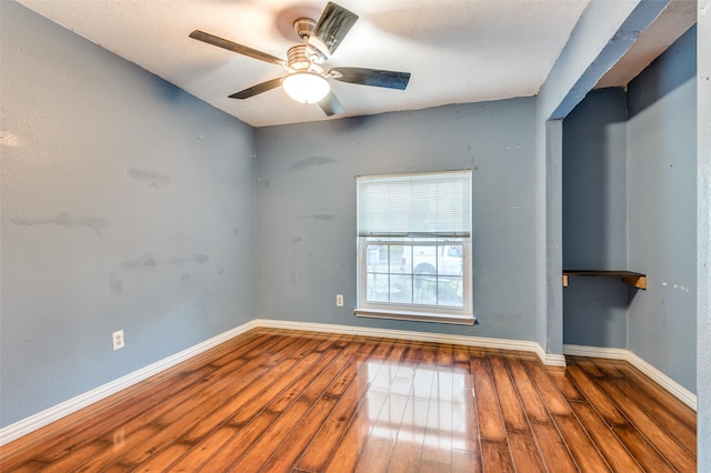 spare room with ceiling fan and dark hardwood / wood-style flooring