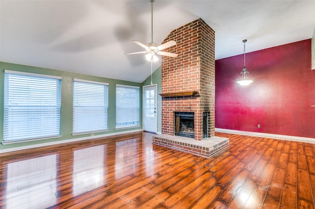 unfurnished living room featuring hardwood / wood-style flooring, ceiling fan, a fireplace, and vaulted ceiling