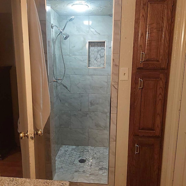 bathroom with a tile shower