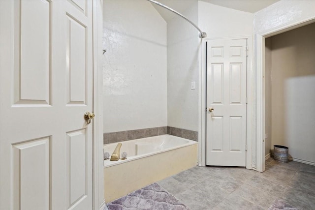 bathroom featuring a tub to relax in