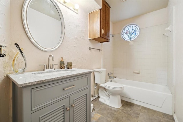 full bathroom with vanity, toilet, and tiled shower / bath combo