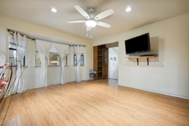 doorway to outside featuring ceiling fan, light tile patterned flooring, and a textured ceiling