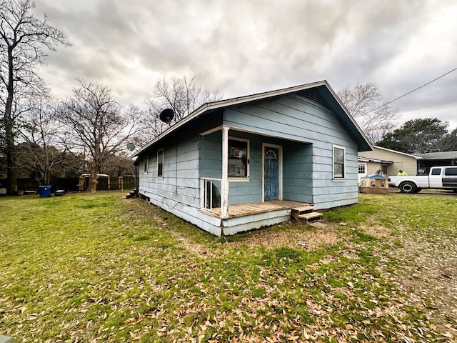 bungalow with a porch and a front lawn