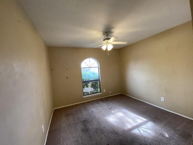 empty room with ceiling fan and carpet floors