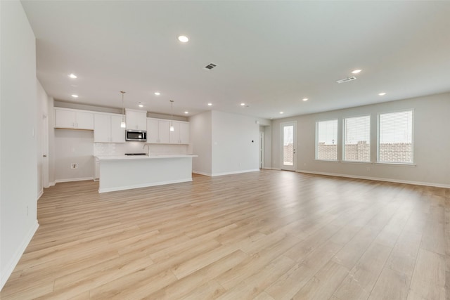 unfurnished living room featuring light hardwood / wood-style flooring