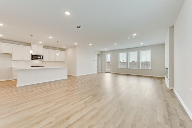 unfurnished living room featuring light wood-type flooring