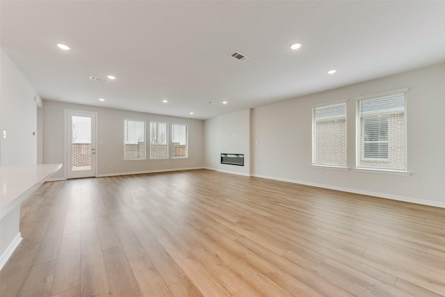 unfurnished living room with light hardwood / wood-style floors