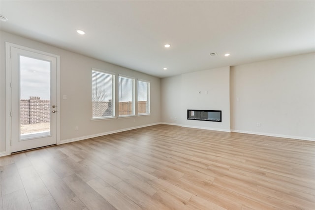 unfurnished living room with light hardwood / wood-style floors