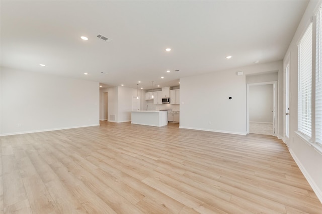 unfurnished living room featuring light wood-type flooring