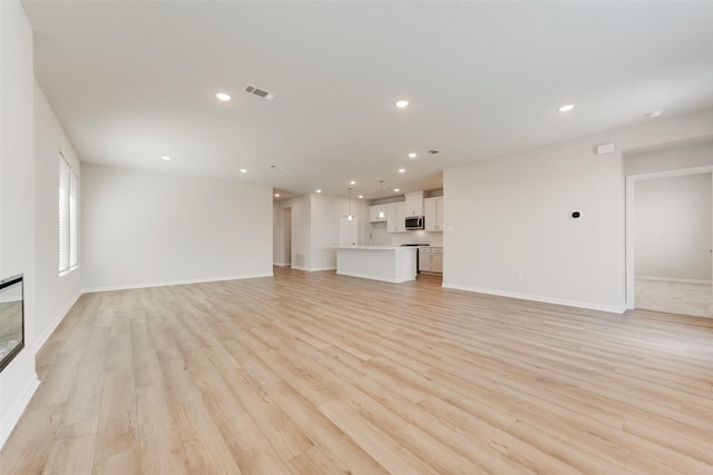 unfurnished living room featuring light hardwood / wood-style floors