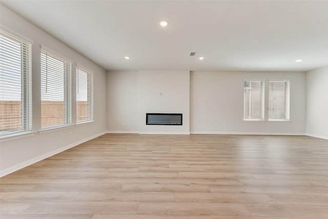 unfurnished living room featuring light hardwood / wood-style floors