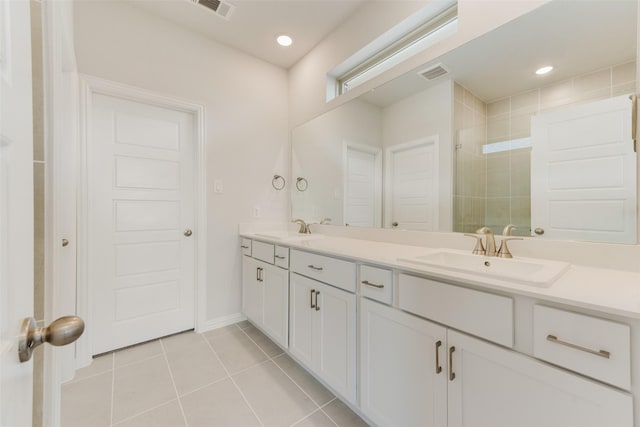 bathroom featuring walk in shower, vanity, and tile patterned flooring