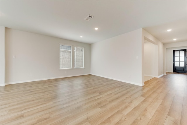 unfurnished room with light wood-type flooring