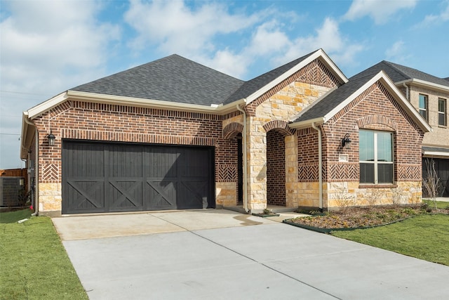 view of front of property with cooling unit, a garage, and a front yard