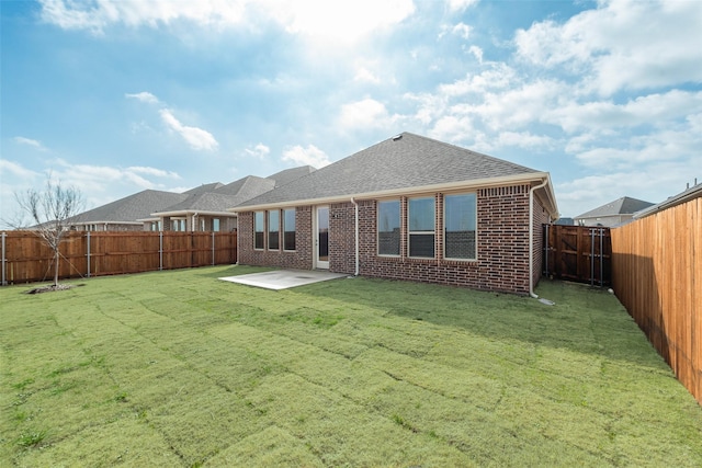 rear view of house with a lawn and a patio area