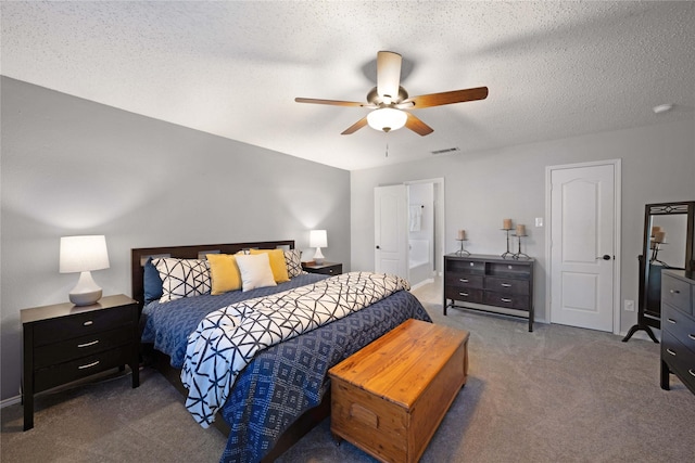 bedroom featuring ceiling fan, carpet floors, and a textured ceiling