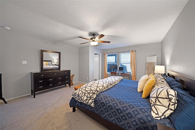 carpeted bedroom featuring a textured ceiling and ceiling fan