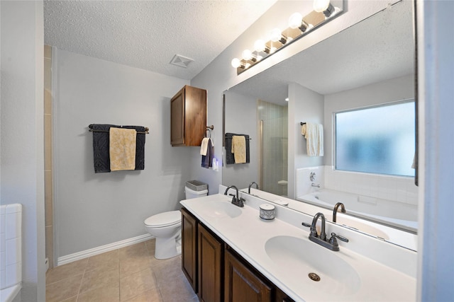 full bathroom with vanity, a textured ceiling, plus walk in shower, tile patterned flooring, and toilet