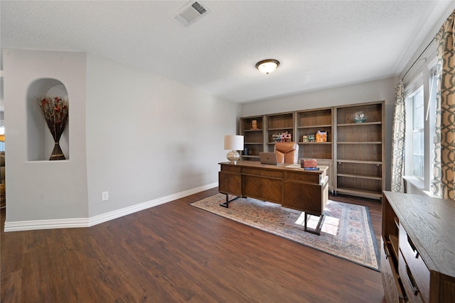 home office featuring a textured ceiling and dark hardwood / wood-style floors