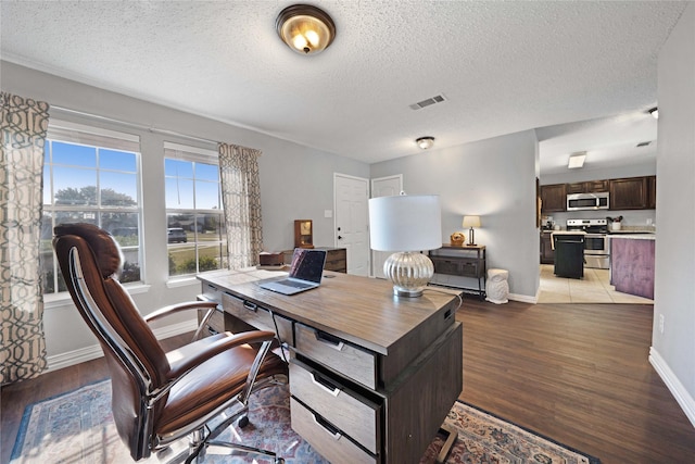 office space featuring light hardwood / wood-style flooring and a textured ceiling