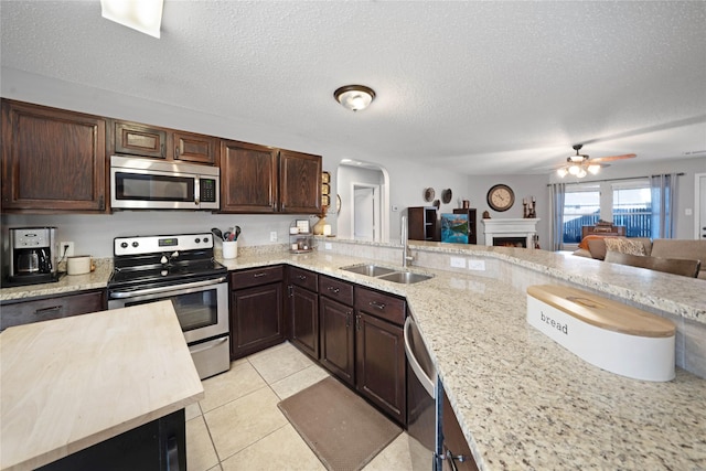 kitchen featuring sink, a textured ceiling, and appliances with stainless steel finishes