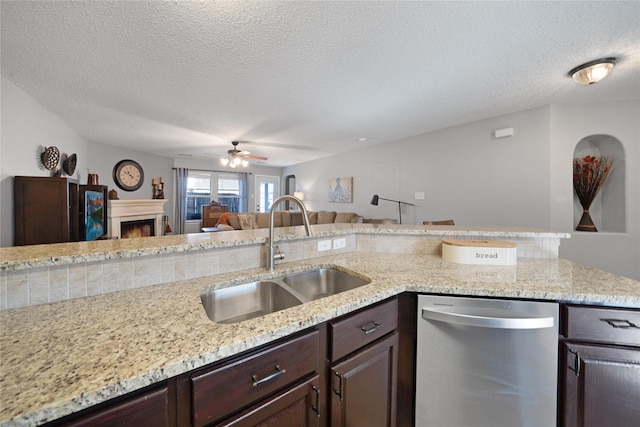 kitchen with dark brown cabinetry, dishwasher, a textured ceiling, and sink