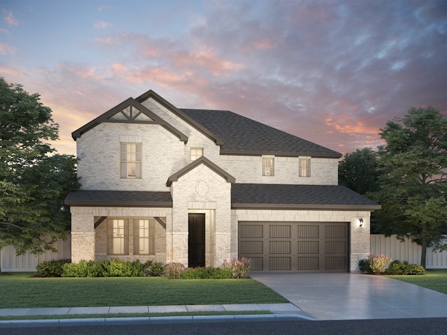 view of front of home featuring a yard and a garage