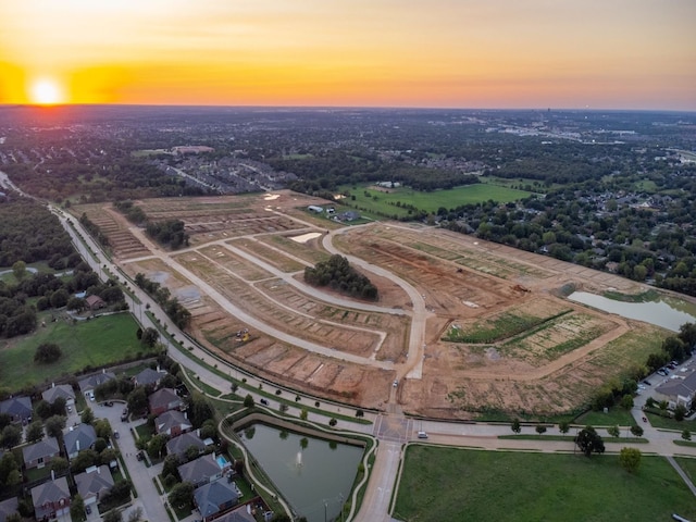 aerial view at dusk with a water view