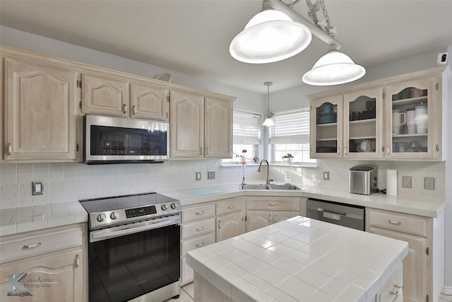 kitchen featuring sink, tile countertops, light brown cabinets, stainless steel appliances, and backsplash