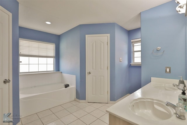 bathroom featuring vanity, a tub to relax in, and tile patterned floors