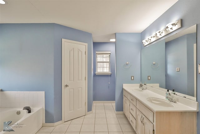 bathroom featuring tile patterned flooring, vanity, and a washtub