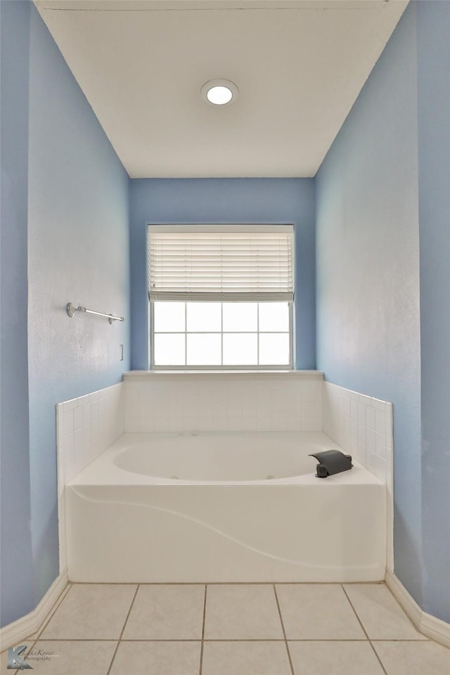 bathroom with tile patterned flooring and a bathtub