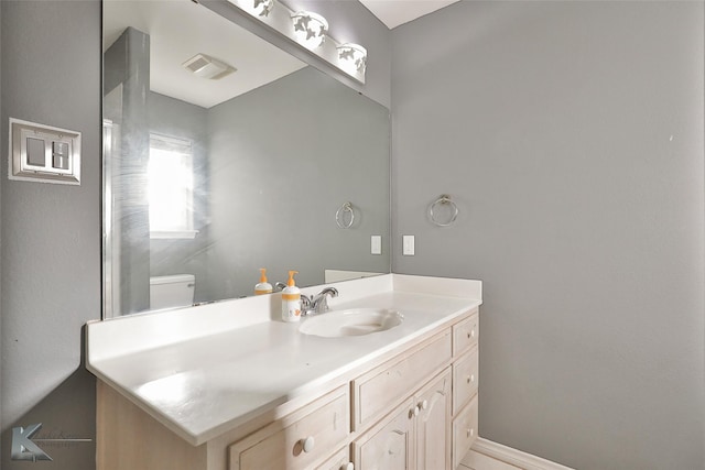 bathroom with vanity and toilet