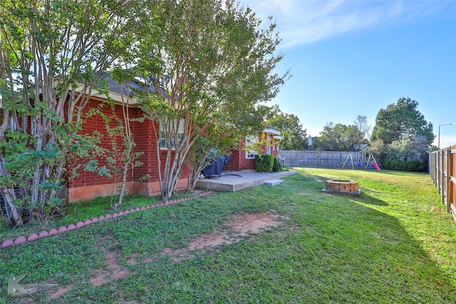 view of yard with a fire pit and a playground