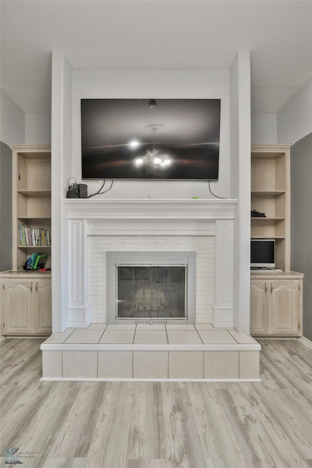 details with a fireplace and wood-type flooring