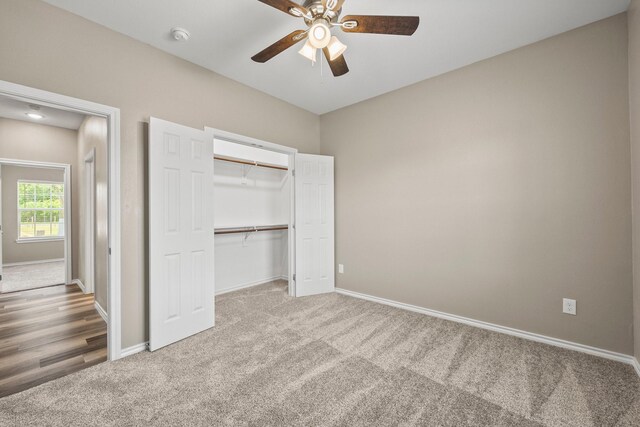 unfurnished bedroom featuring ceiling fan, carpet flooring, and a closet