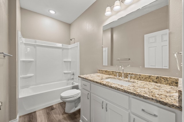 full bathroom with hardwood / wood-style flooring,  shower combination, toilet, and vanity