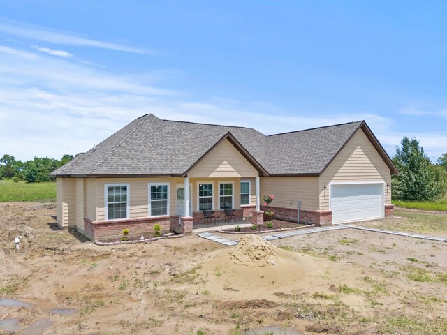 view of front of home featuring a garage and covered porch