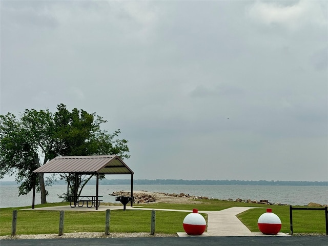view of community with a gazebo, a water view, and a lawn