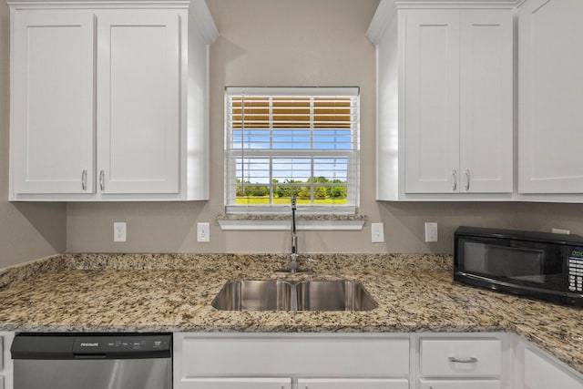 kitchen featuring white cabinetry, stainless steel dishwasher, a sink, black microwave, and light stone countertops