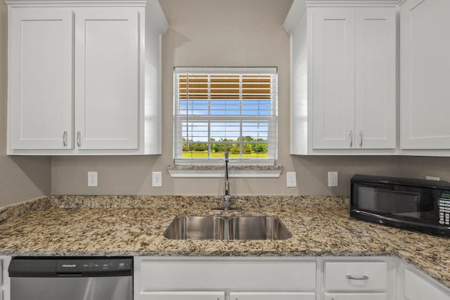 kitchen with light stone counters, dishwasher, sink, and white cabinets