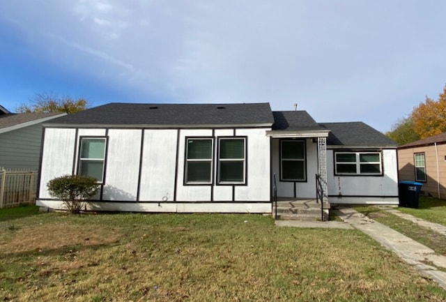 back of house featuring a lawn