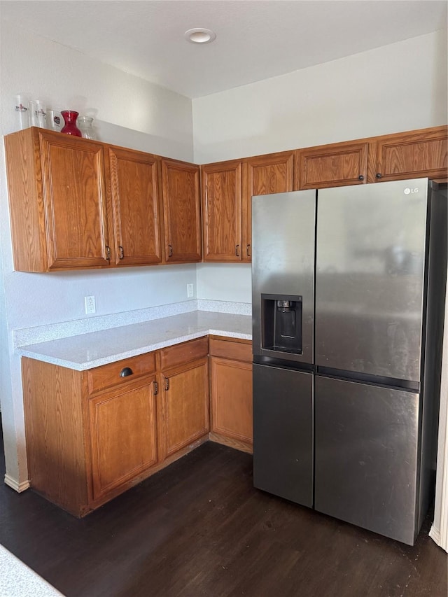 kitchen featuring dark hardwood / wood-style floors and stainless steel refrigerator with ice dispenser