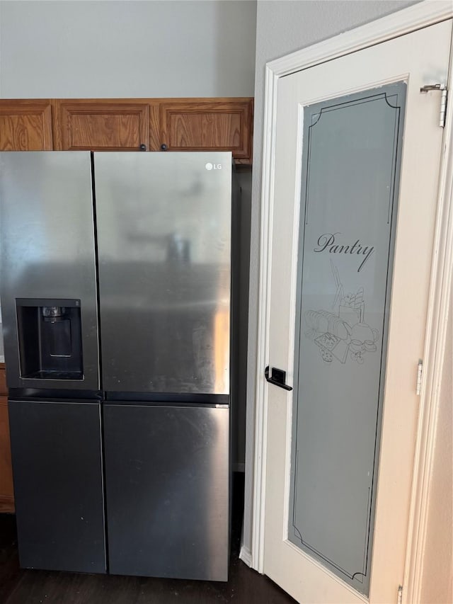 kitchen featuring stainless steel refrigerator with ice dispenser